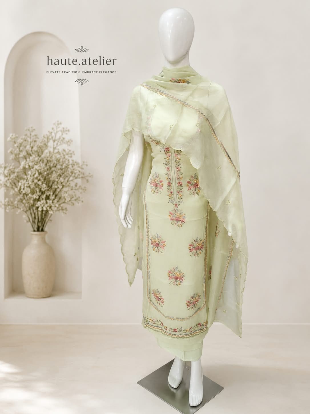An ivory satin cotton suit printed with black polka dots and rose clusters, trimmed in a black-and-white striped border